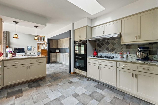 3063 Wedgewood Dr, Dekalb, IL 60115 - kitchen featuring black appliances, under cabinet range hood, stone finish floors, backsplash, and hanging light fixtures