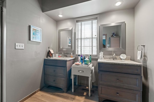 3063 Wedgewood Dr, Dekalb, IL 60115 - bathroom featuring two vanities and wood finished floors