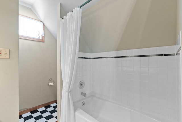 3063 Wedgewood Dr, Dekalb, IL 60115 - bathroom with tile patterned floors, shower / bath combo with shower curtain, and vaulted ceiling