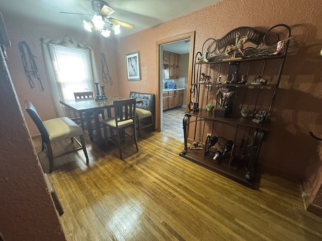 624 16th Ave, Sterling, IL 61081 - dining room featuring a textured wall, wood finished floors, and a ceiling fan