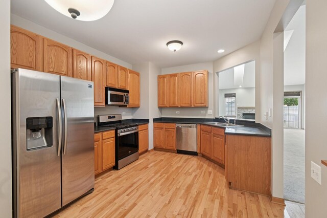 11636 Waterway Ct, Orland Park, IL 60467 - kitchen featuring stainless steel appliances, dark countertops, light wood-style flooring, and recessed lighting