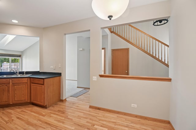 11636 Waterway Ct, Orland Park, IL 60467 - kitchen with light wood-type flooring, brown cabinets, dark countertops, and recessed lighting