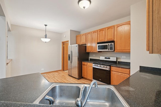 11636 Waterway Ct, Orland Park, IL 60467 - kitchen featuring appliances with stainless steel finishes, dark countertops, and decorative light fixtures
