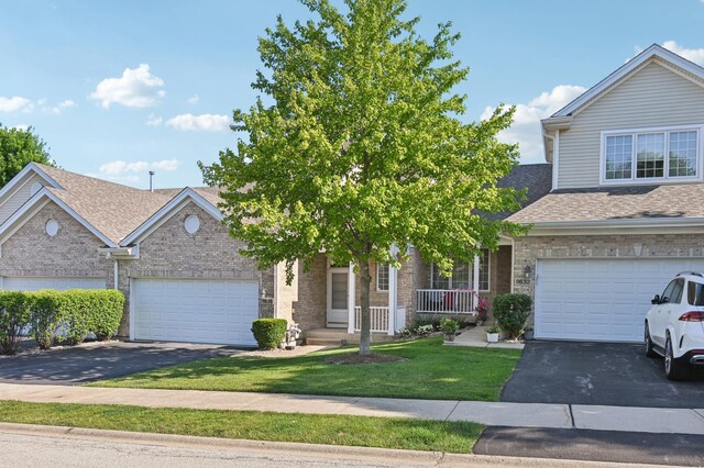 11636 Waterway Ct, Orland Park, IL 60467 - view of front of home with driveway, brick siding, a front lawn, and covered porch