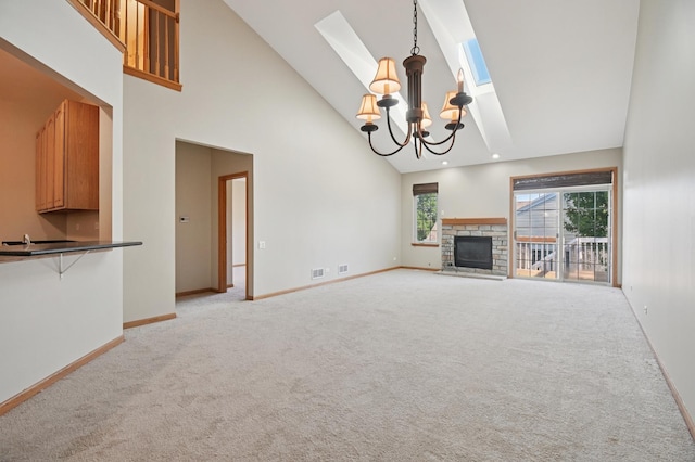 11636 Waterway Ct, Orland Park, IL 60467 - unfurnished living room with high vaulted ceiling, a chandelier, light carpet, a stone fireplace, and a skylight
