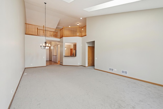 11636 Waterway Ct, Orland Park, IL 60467 - unfurnished living room with a chandelier, a skylight, high vaulted ceiling, and light colored carpet