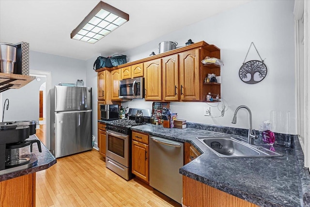 126 N Austin Blvd Unit 2N, Oak Park, IL 60302 - kitchen featuring appliances with stainless steel finishes, light wood-type flooring, dark countertops, and brown cabinetry