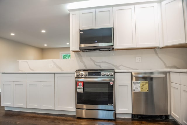 1028 Valley Stream Dr, Wheeling, IL 60090 - kitchen featuring appliances with stainless steel finishes, white cabinetry, dark wood-style flooring, and recessed lighting
