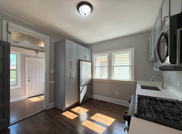 30 E 102nd St, Chicago, IL 60628 - kitchen with appliances with stainless steel finishes, dark wood-style floors, light countertops, and gray cabinetry