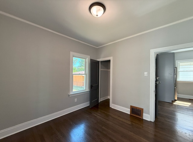 30 E 102nd St, Chicago, IL 60628 - unfurnished bedroom featuring ornamental molding, dark wood finished floors, and a closet