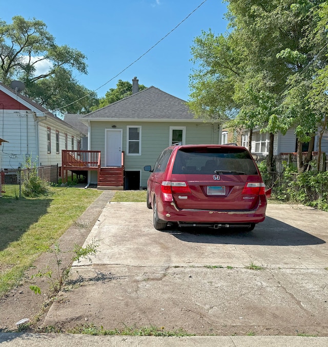 30 E 102nd St, Chicago, IL 60628 - view of front facade featuring a deck, roof with shingles, and a chimney