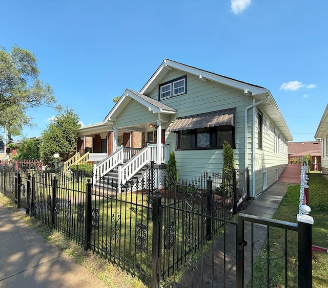 30 E 102nd St, Chicago, IL 60628 - bungalow-style house featuring a porch and a fenced front yard
