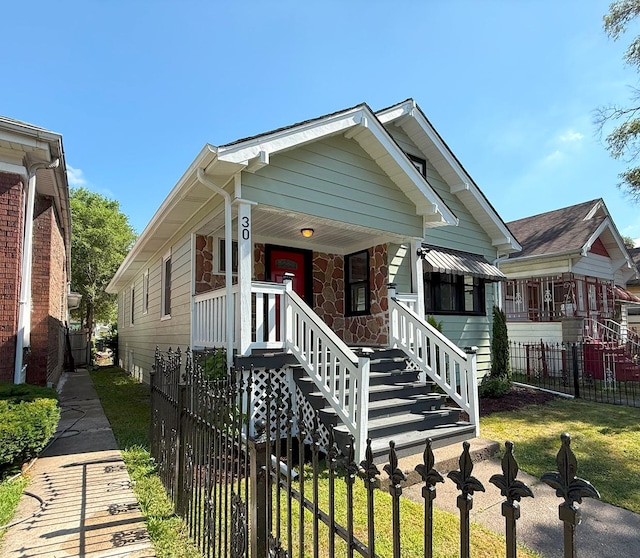 30 E 102nd St, Chicago, IL 60628 - view of front facade featuring a porch and stone siding
