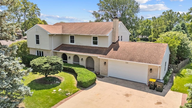 739 Crest Ave, Schaumburg, IL 60193 - traditional-style house with brick siding, an attached garage, a chimney, and driveway