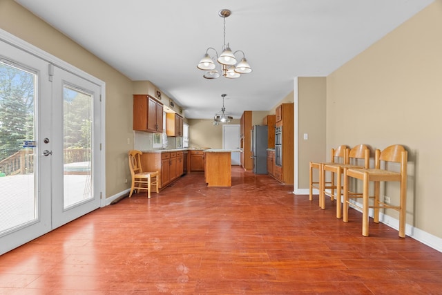 739 Crest Ave, Schaumburg, IL 60193 - kitchen with appliances with stainless steel finishes, a chandelier, brown cabinetry, and wood finished floors