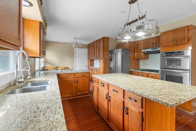 739 Crest Ave, Schaumburg, IL 60193 - kitchen with appliances with stainless steel finishes, under cabinet range hood, backsplash, and light stone countertops