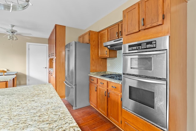739 Crest Ave, Schaumburg, IL 60193 - kitchen with appliances with stainless steel finishes, under cabinet range hood, dark wood-type flooring, tasteful backsplash, and a ceiling fan