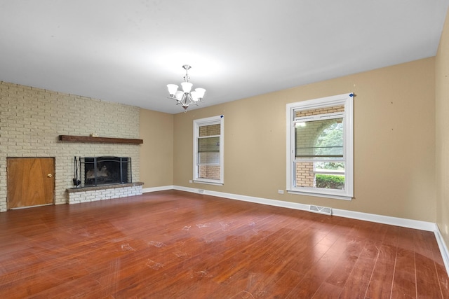 739 Crest Ave, Schaumburg, IL 60193 - unfurnished living room with a chandelier, wood finished floors, and a fireplace