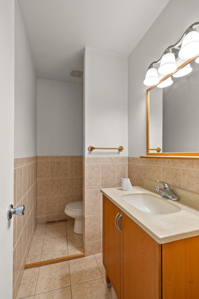 739 Crest Ave, Schaumburg, IL 60193 - bathroom with tile walls, vanity, wainscoting, and tile patterned floors