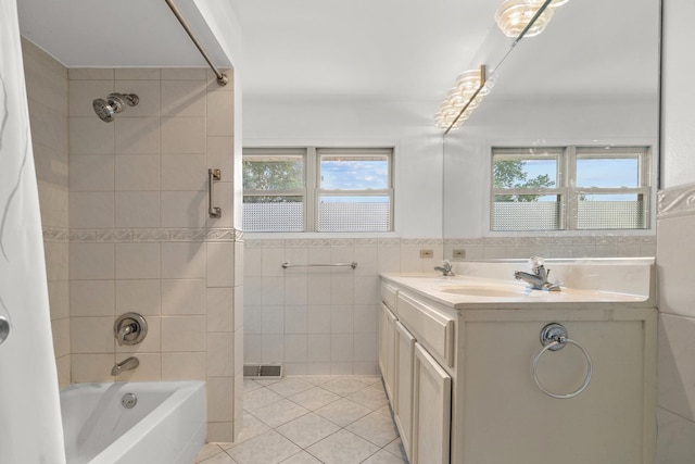 739 Crest Ave, Schaumburg, IL 60193 - full bath with shower / washtub combination, tile patterned flooring, plenty of natural light, double vanity, and tile walls