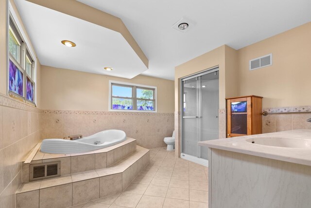 739 Crest Ave, Schaumburg, IL 60193 - full bathroom with tile walls, tile patterned floors, a bidet, a bath, and wainscoting