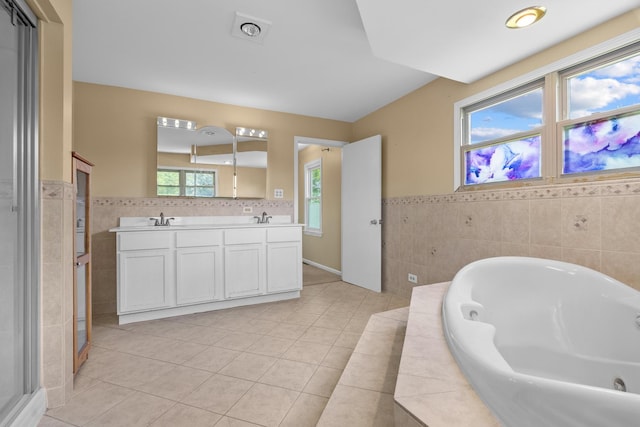 739 Crest Ave, Schaumburg, IL 60193 - bathroom featuring tile walls, double vanity, a tub with jets, tile patterned flooring, and wainscoting