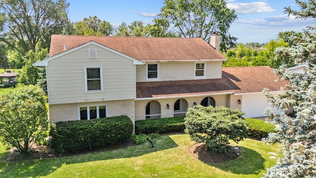 739 Crest Ave, Schaumburg, IL 60193 - view of front of house with brick siding, a front lawn, a chimney, an attached garage, and roof with shingles