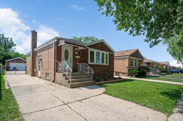 7826 S Kenneth Ave, Chicago, IL 60652 - view of front of home with an outbuilding, a chimney, a front lawn, a garage, and brick siding