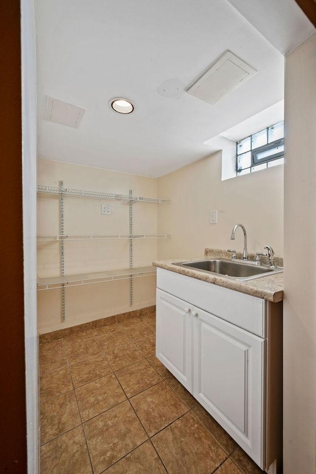 7826 S Kenneth Ave, Chicago, IL 60652 - kitchen with light countertops, white cabinets, light tile patterned floors, and recessed lighting