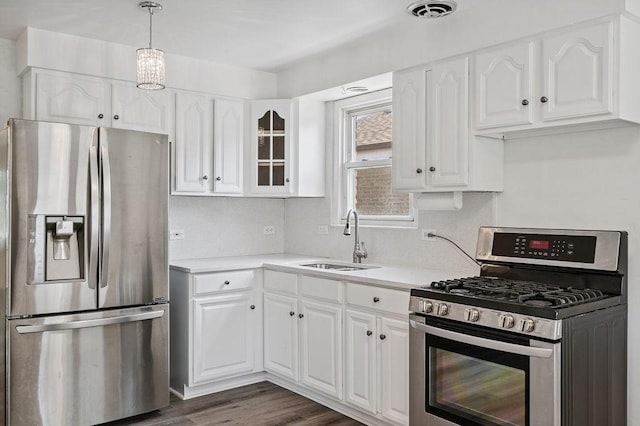 7826 S Kenneth Ave, Chicago, IL 60652 - kitchen with appliances with stainless steel finishes, white cabinetry, light countertops, and glass insert cabinets
