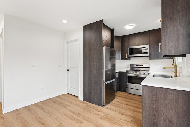 1516 Laguna Ct, Wheeling, IL 60090 - kitchen with appliances with stainless steel finishes, dark brown cabinets, light wood-style flooring, and light countertops