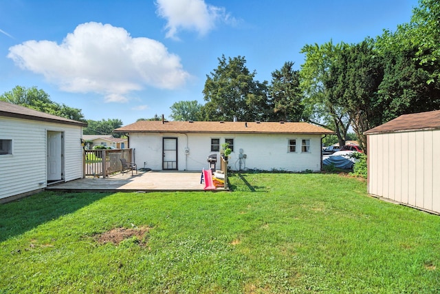 34W928 N James Dr, Saint Charles, IL 60174 - back of house featuring a lawn, an outdoor structure, and a deck