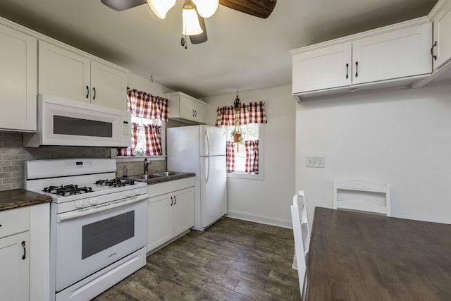 10415 W Ames Ave, Beach Park, IL 60087 - kitchen featuring white appliances, dark countertops, a ceiling fan, backsplash, and dark wood finished floors