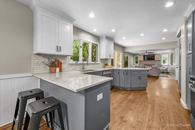 515 Timbers Trl, Saint Charles, IL 60174 - kitchen with a peninsula, open floor plan, gray cabinets, light wood-type flooring, and light stone countertops
