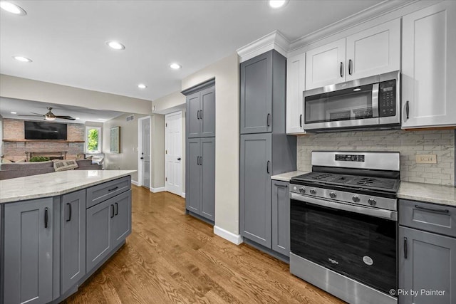 515 Timbers Trl, Saint Charles, IL 60174 - kitchen with appliances with stainless steel finishes, gray cabinets, a ceiling fan, open floor plan, and wood finished floors