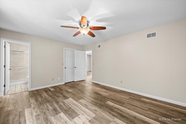 515 Timbers Trl, Saint Charles, IL 60174 - unfurnished bedroom with wood finished floors, ensuite bathroom, and a ceiling fan