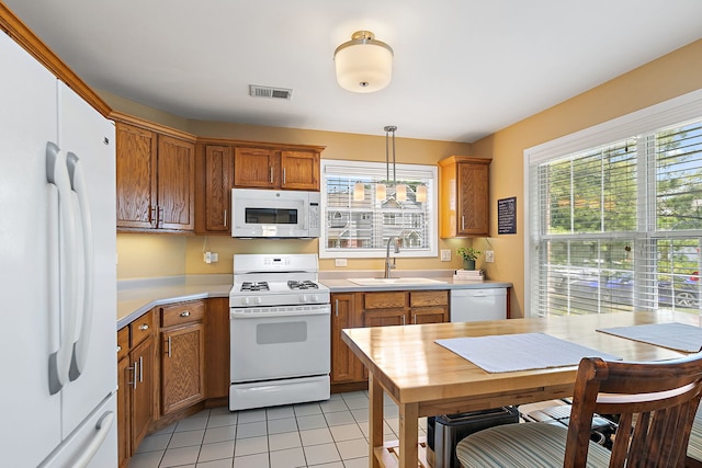 322 Winfield Ct, Schaumburg, IL 60194 - kitchen with white appliances, light countertops, brown cabinetry, and light tile patterned flooring