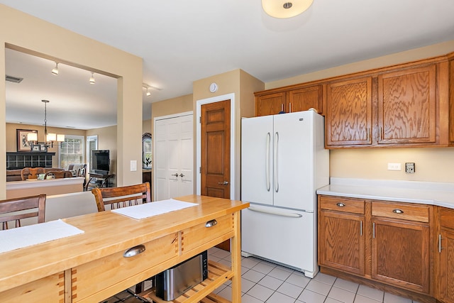 322 Winfield Ct, Schaumburg, IL 60194 - kitchen featuring freestanding refrigerator, brown cabinets, and light tile patterned floors
