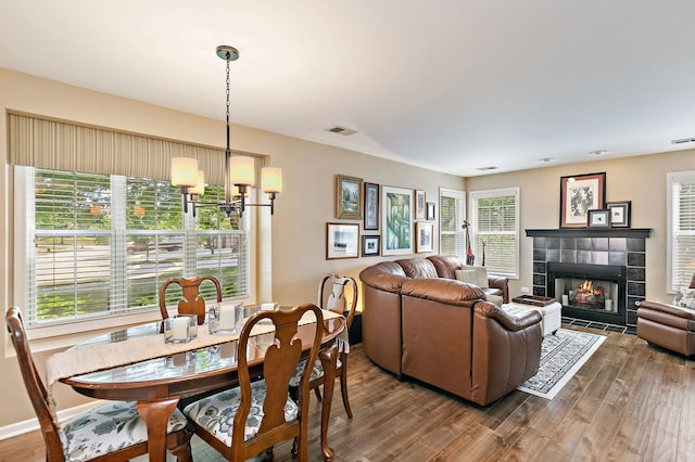 322 Winfield Ct, Schaumburg, IL 60194 - dining area with dark wood-style floors, a chandelier, and a tiled fireplace