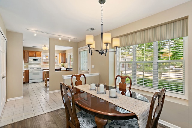 322 Winfield Ct, Schaumburg, IL 60194 - tiled dining room featuring a chandelier and rail lighting