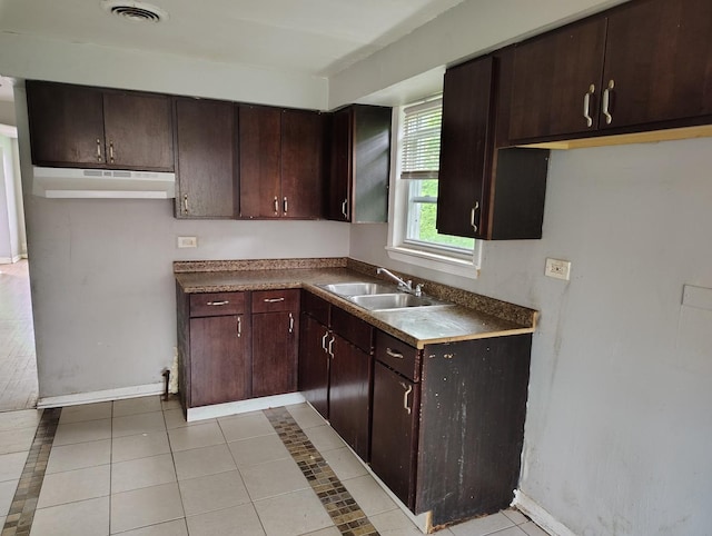8924 S Paulina St, Chicago, IL 60620 - kitchen featuring under cabinet range hood, light tile patterned flooring, and dark brown cabinets
