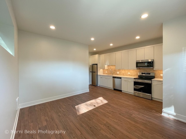 18 W 44th St, Chicago, IL 60609 - kitchen featuring stainless steel appliances, dark wood-style flooring, white cabinetry, decorative backsplash, and recessed lighting