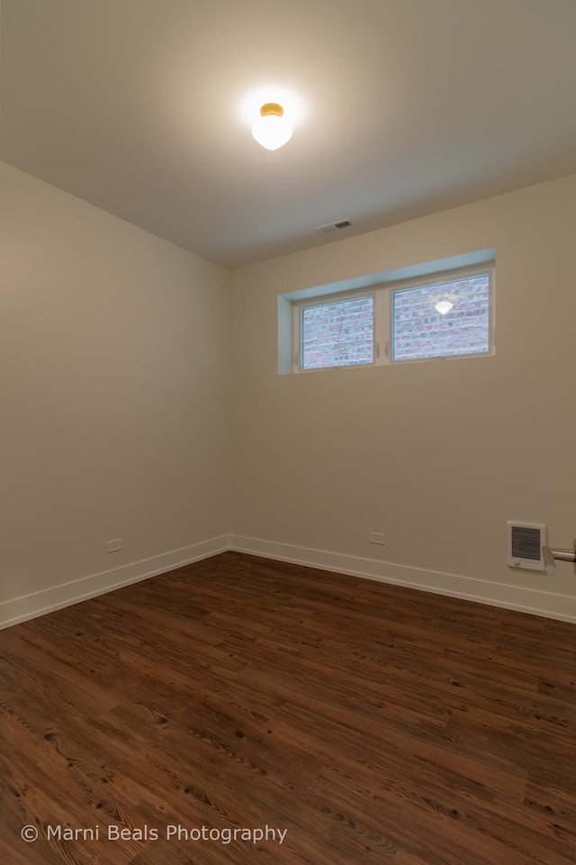 18 W 44th St, Chicago, IL 60609 - unfurnished room with baseboards and dark wood-type flooring