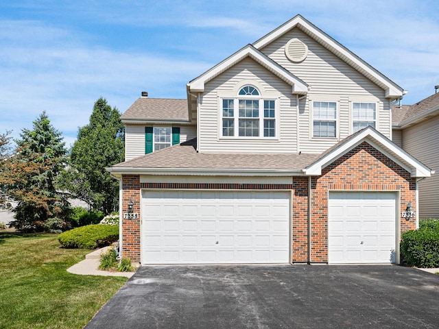 7358 Grandview Ct Unit 7358, Carpentersville, IL 60110 - view of front of home with driveway, an attached garage, brick siding, a front lawn, and a shingled roof
