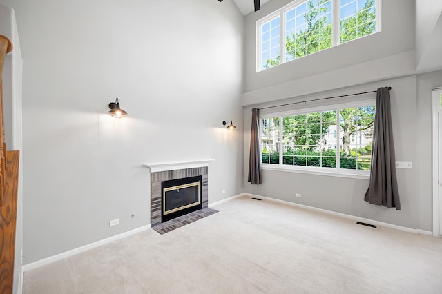 7358 Grandview Ct Unit 7358, Carpentersville, IL 60110 - unfurnished living room with a towering ceiling, carpet flooring, a brick fireplace, and healthy amount of natural light