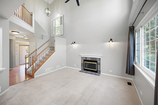 7358 Grandview Ct Unit 7358, Carpentersville, IL 60110 - unfurnished living room with stairway, a high ceiling, carpet floors, a brick fireplace, and a chandelier