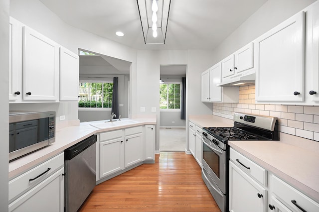7358 Grandview Ct Unit 7358, Carpentersville, IL 60110 - kitchen with stainless steel appliances, white cabinets, light wood-type flooring, light countertops, and under cabinet range hood