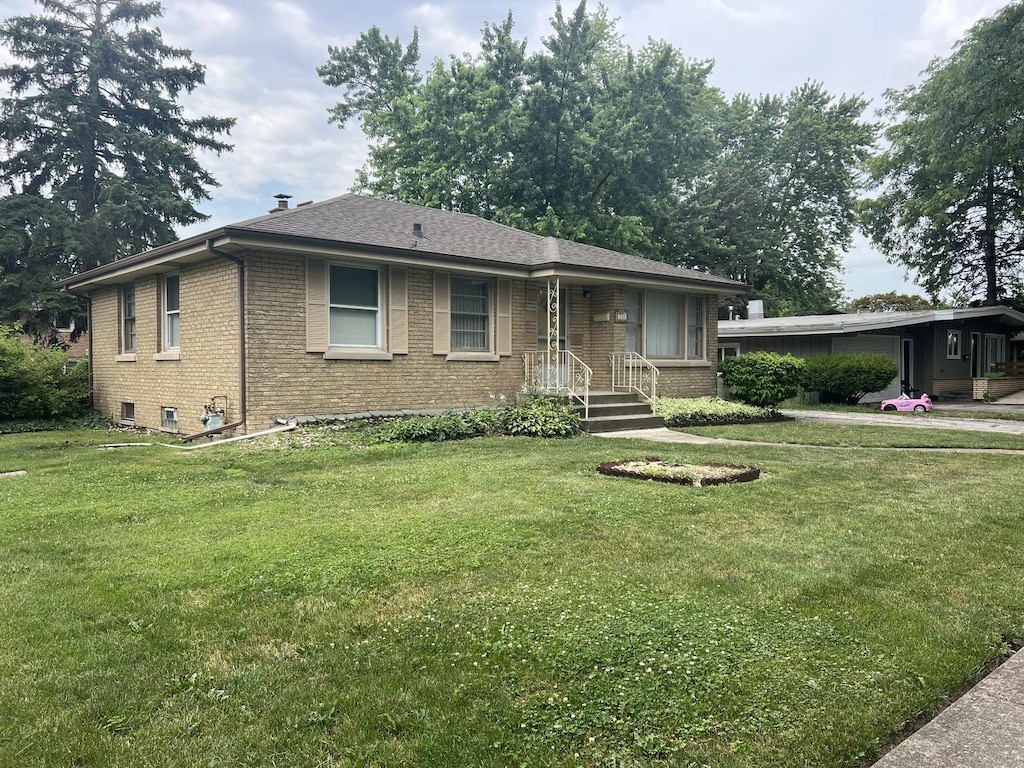 243 E 170th St, South Holland, IL 60473 - ranch-style house with brick siding, a front yard, and roof with shingles