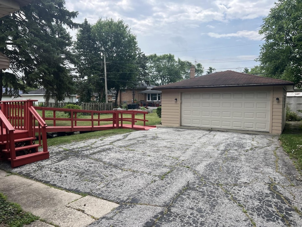 243 E 170th St, South Holland, IL 60473 - view of front facade with a detached garage, an outdoor structure, a deck, and a chimney