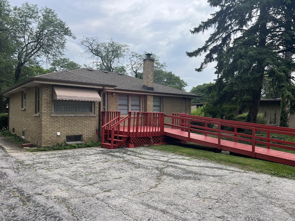 243 E 170th St, South Holland, IL 60473 - rear view of property featuring brick siding, a deck, a chimney, and roof with shingles